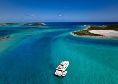 Aerial view of boat in turquoise water.