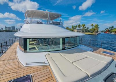 Luxury yacht docked near waterfront city.