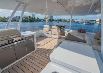 Luxury boat deck with grill and seating.