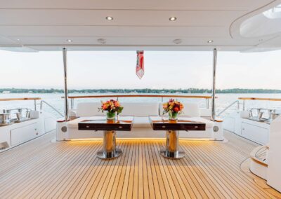 Luxury yacht deck with flowers and seating.