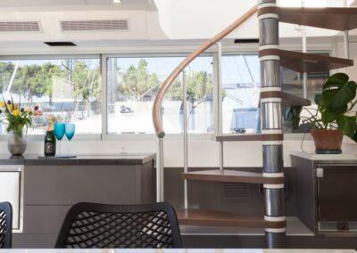 Modern interior with spiral staircase and plants.