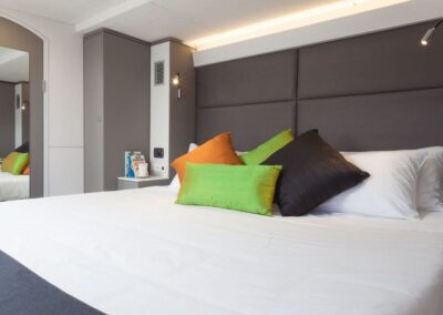 Cozy bedroom with colorful decorative pillows.