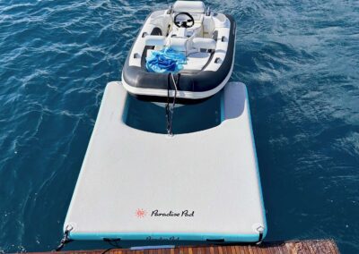 Inflatable boat on a floating pad.