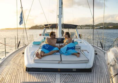 Couple relaxing on a yacht at sunset.