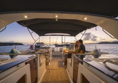 Couple dining on a boat at sunset.