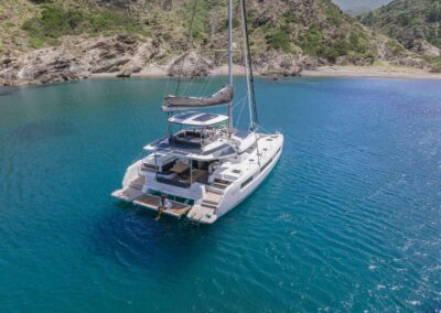 Luxury catamaran anchored in serene turquoise water.