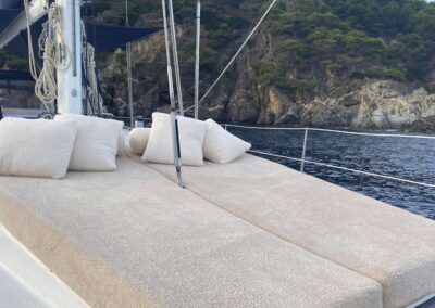 Lounge cushions on a boat by the coast.